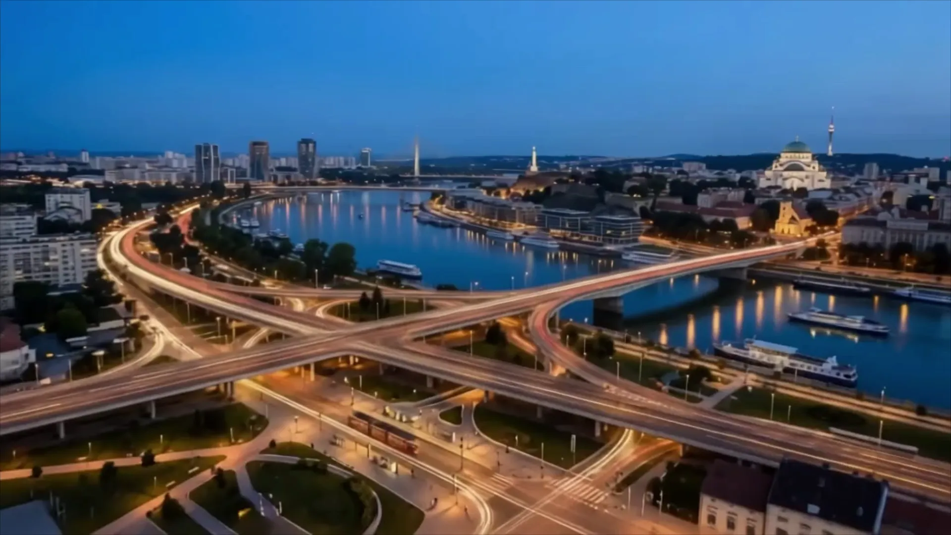Aerial view of Belgrade at dusk — the river, bridges and the Temple of Saint Sava